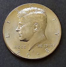 2018-D Kennedy half dollar with missing clad layer error — one side showing exposed copper core instead of standard nickel-clad surface